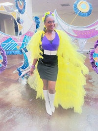 a woman in a colorful costume poses for a photo