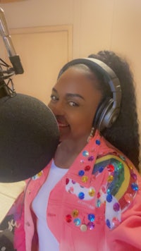 a woman with headphones in front of a microphone