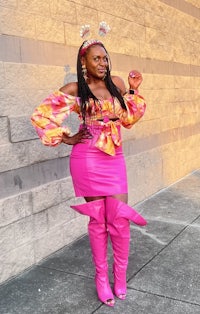 a woman wearing a pink dress and thigh high boots